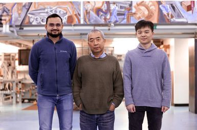 Professor Pingsha Dong (center), the Robert F. Beck Collegiate Professor of Engineering, surrounded by Abdul Khan (left), and Yuning Zhang, both PhD students in naval architecture and marine engineering, at the Herbert H. Dow Building. Their research involves welding plastic to metal in a newly discovered technique where a thin strip of a nylon-6 (PA6) film provides the oxygen needed to force the formation of a nice, connected interface between the metal and plastic. Image credit: Brenda Ahearn, College of Engineering