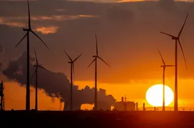sunset behind an array of windmills