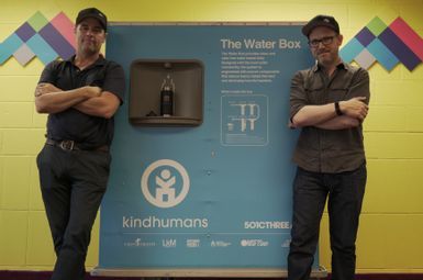 SEAS grad student Jaron Rothkop and Drew FitzGerald stand next to a Water Box at the Sylvester Broome Empowerment Village in Flint, MI.