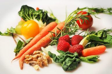 Carrots, walnuts, greens, raspberries, and tomatoes