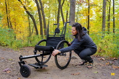 Kiley Adams shows off the trailchair. Photo by UMSocial.