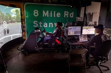 Researchers use a simulator made by VI-grade that allows the driver to teleoperate an autonomous vehicle remotely on the facility’s real-world test track. Credit: Marcin Szczepanski/Michigan Engineering