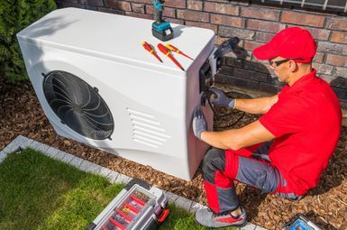 a technician working on a heat pump