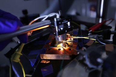 To measure the power produced by his photovoltaic cells, Roy-Layinde holds a heat source held over the photovoltaic cell, which emits the infrared radiation that the cell converts into electricity. Wires connected to the photovoltaic cell run the electricity to a sensor that reads the voltage and amperage. Image credit: Brenda Ahearn, Michigan Engineering.