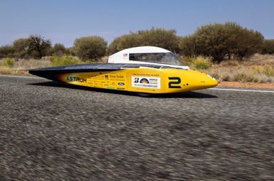 Ethan Lei, University of Michigan Solar Car Team driver and U-M mechanical engineering undergraduate student, drives his team’s car, Astrum, along the Stuart Highway south of Erldunda, Australia on October 24, 2023 as part of the 2023 Bridgestone World Solar Challenge. Image credit: Levi Hutmacher, Michigan Engineering