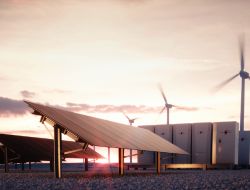 Solar panels and wind turbines at sunset