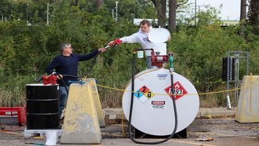 Researchers working on an above ground fuel tank