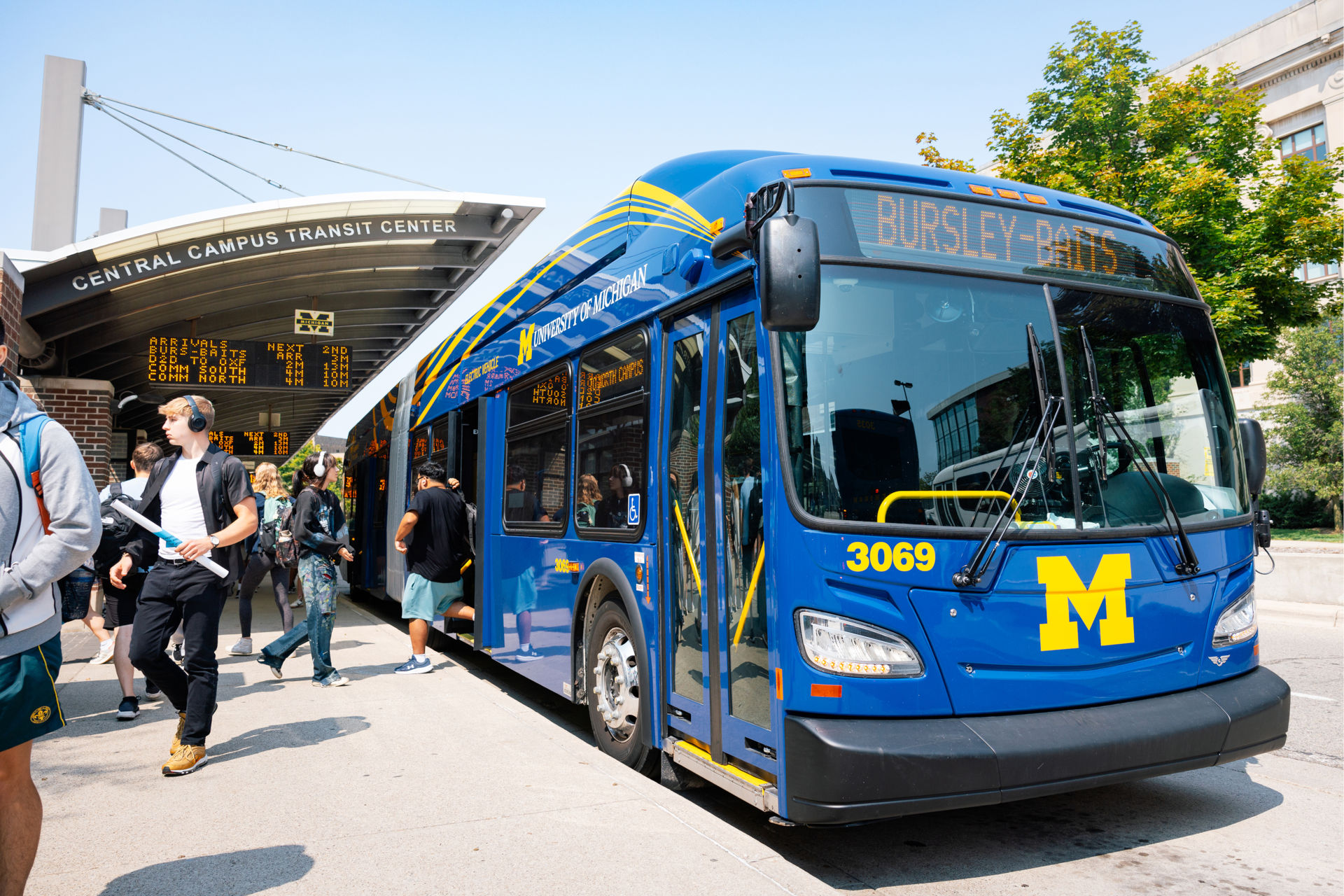 Students getting on and off of campus buses at the Central Campus Transit Center