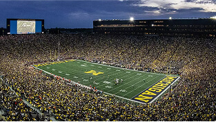 A full Michigan Stadium during a football game in fall